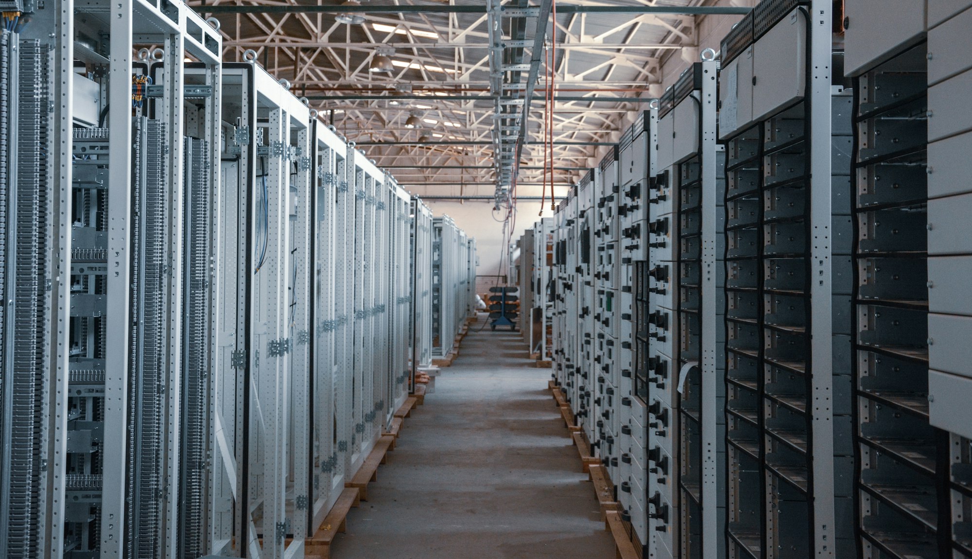 A long corridor of caged server racks inside a data hall